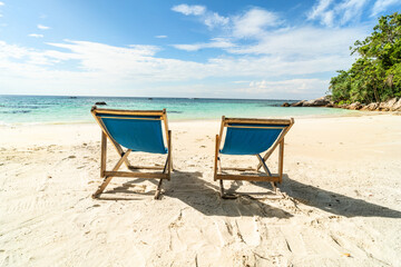 Empty tropical beach landscape. Travel vacations destination. Sunbeds on the sand. Tourism.