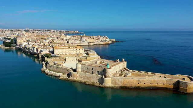 Siracusa, Ortigia Island from the air, Sicily, Italy. Isola di Ortigia, coast of Ortigia island at city of Syracuse, Sicily, Italy. Coastline town Syracuse, Sicily and old Ortigia island. Aerial view.