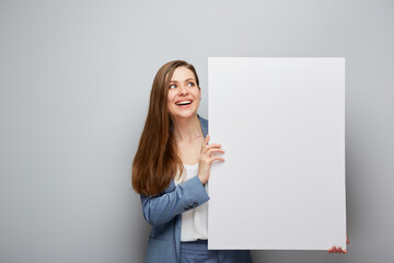 Smiling woman holding big empty banner. - 562530846