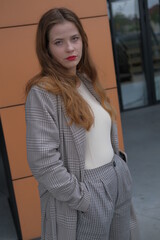 Business women in the elegant classic clothes. City portrait of the girl