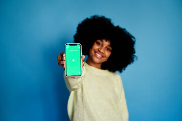 Smiling black woman with smartphone green screen