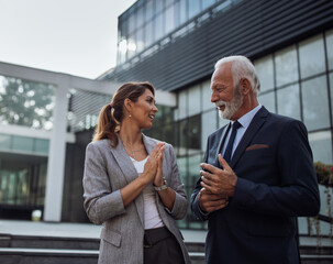 Business people talking in front of office building