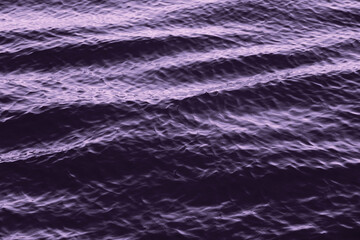Wavy abstract purplish surface of rippled and wavy sea