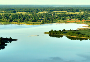 Rural landscape. Country houses in countryside, aerial view. Drink water safe. Global drought crisis. Pond in countryside with fields and forest. Wetland in green colors. Rural environment, Drone view