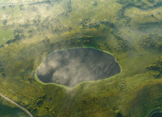Lake in fog, drone view. Morning mist haze in rural. Rural landscape with lakes. Drink water. Village at lake in mist haze. Freshwater Lakes. Fog over country with lake. Country in Foggy landscape.
