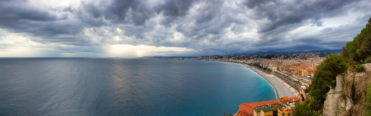 Sandy Beach by Historic City of Nice, France. View from Castle Hill. Cloudy Evening before Sunset. Panorama