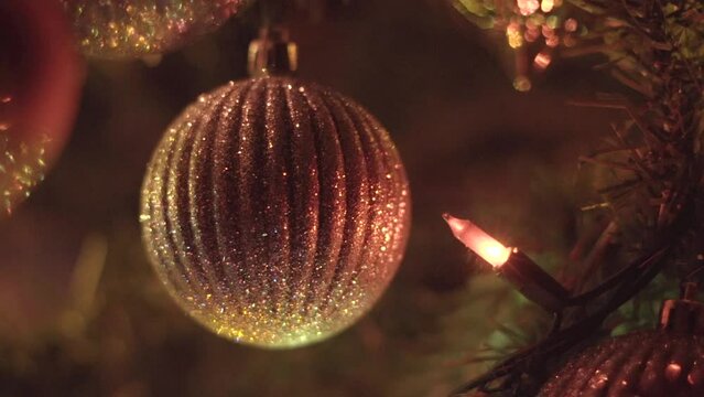 Christmas ornament hanging on tree. Close up colourful macro shot