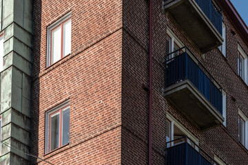 Fototapeta na wymiar Looking up a corner of a brick apartment building.