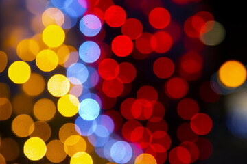 background blurred abstraction of colored lanterns and decorations. bokeh texture of street colored lights