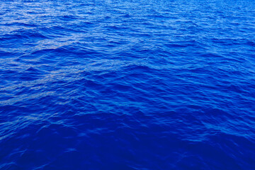 Very nice sea water background or backdrop with selective focus. Small waves of natural water surface texture.