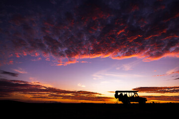 Silhouette of a safari truck at sunrise