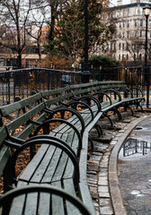Fototapeta na wymiar Park benches for sitting and relaxing in New York City. Downtown urban park center