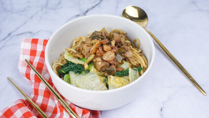 Indonesian food, Mie Ayam or Bami ayam, noodles with chicken and served on white bowl