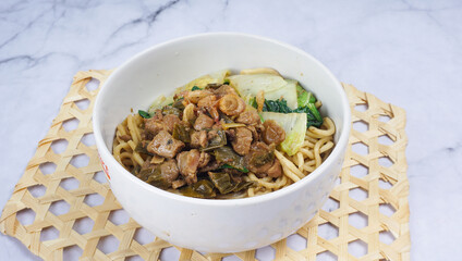 Indonesian food, Mie Ayam or Bami ayam, noodles with chicken and served on white bowl