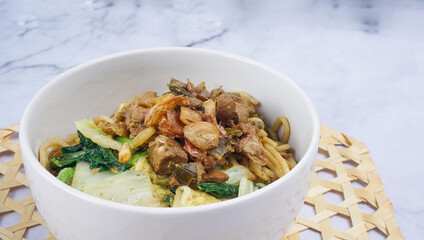 Indonesian food, mie ayam, noodles with chicken. Served in bowl. Selective focus.