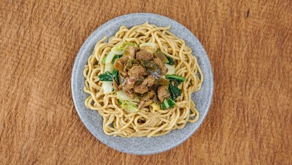 Mie Ayam, Indonesian street food. noodles with chicken ang vegetable served in plate