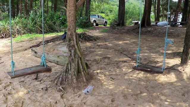 Swing on tree at Naithon Beach bay panorama Phuket Thailand.