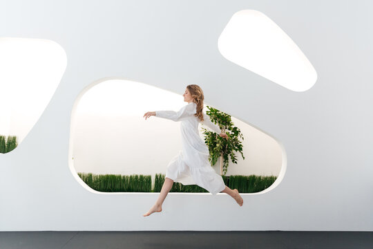 the girl girl runs and rejoices on the interior of the future. the concept of life in a metropolis.