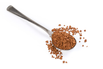 Instant coffee granules in spoon and beside on white surface