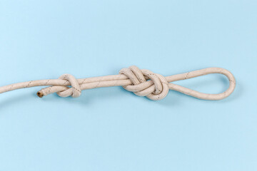 Knot аigure-eight loop with stopper knot on blue background