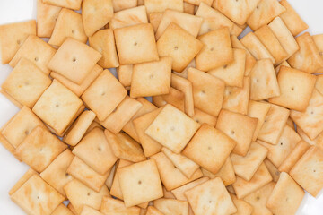 Heap of the salty crackers, top view close-up