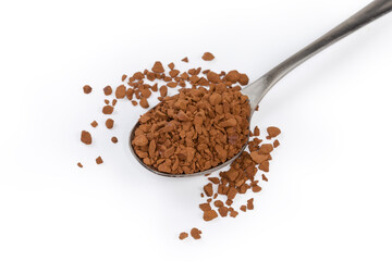 Instant coffee granules in spoon and beside on white surface