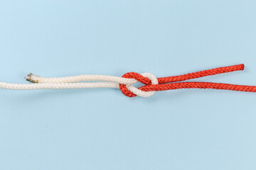 Rope granny knot on a blue background