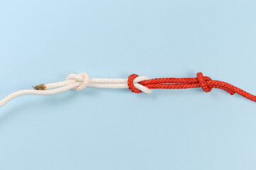 Rope reef knot with stopper knots on a blue background