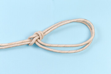 Rope knot bowline on a bight on a blue background