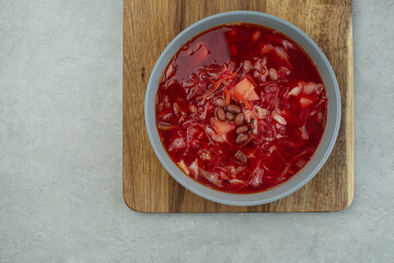 Ukrainian vegetarian borscht with beans on a gray background
