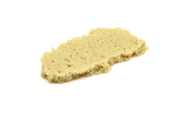 Piece of rye bread isolated on white background.Bite size fragment
