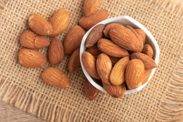 Salted almonds in a white cup.Copy space.