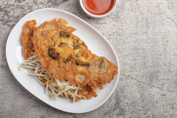 Fried mussels in crispy batter in a white plate