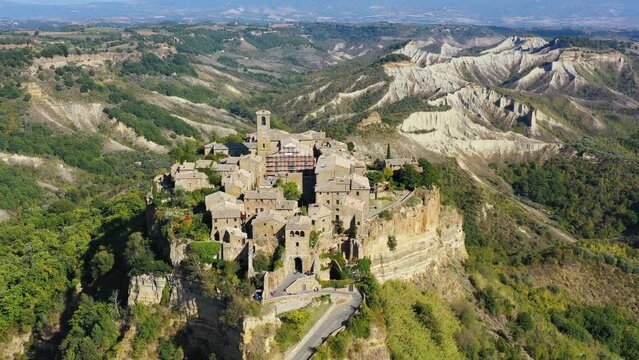 The famous Civita di Bagnoregio on a sunny day. Province of Viterbo, Lazio, Italy. Medieval town on the mountain, Civita di Bagnoregio, popular touristic stop at Tuscany, Italy.