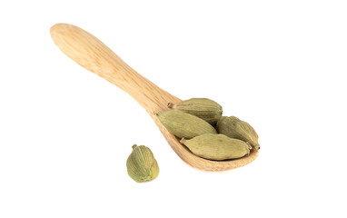 Pods of cardamom on a wooden spoon and on a white background.
