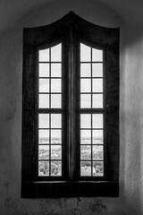 Ancient wooden window of a medieval castle. Background. Black and white.