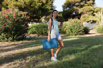 Pretty woman doing yoga in morning park. Healthy lifestyle outdoor conception. Sport. Woman nature portrait doing exercises. Healthy lifestyle.