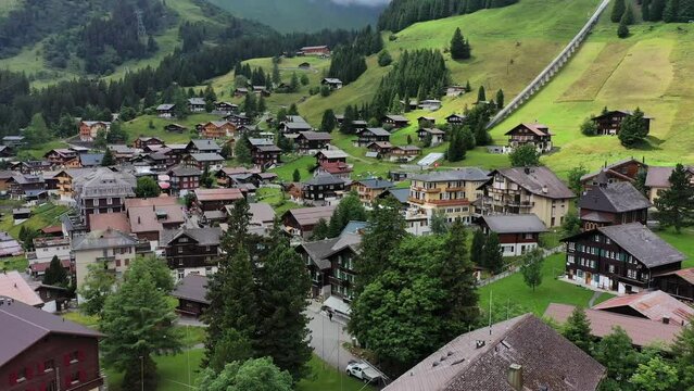 Village of Murren in the Swiss Alps. Village Murren surrounded by mountain peaks of Alps. Murren mountain village with Lauterbrunnen Valley and Swiss Alps, Jungfrau region, Switzerland, Europe.
