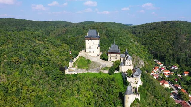 Royal Castle Karlstejn. Central Bohemia, Karlstejn village, Czechia. Aerial view to The Karlstejn castle. Royal palace founded King Charles IV. Amazing gothic monument in Czech Republic, Europe.