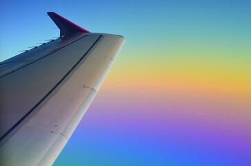 Airplane in the air on a rainbow background