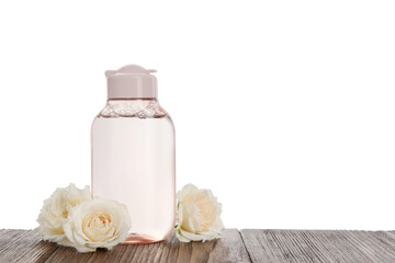 Micellar water and roses on wooden table against white background. Space for text