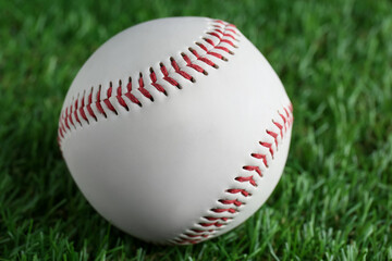 Baseball ball on green grass, closeup. Sports game