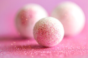 round balls and pink glitter.Abstract background in pink lilac and white colors with round balls.Shiny Festive Background.soft focus.