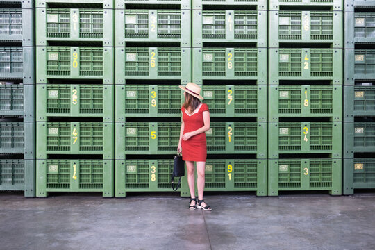 Woman Poses in Front of Green Wall