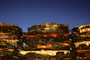 Three stacks of crushed cars in junkyard, USA.