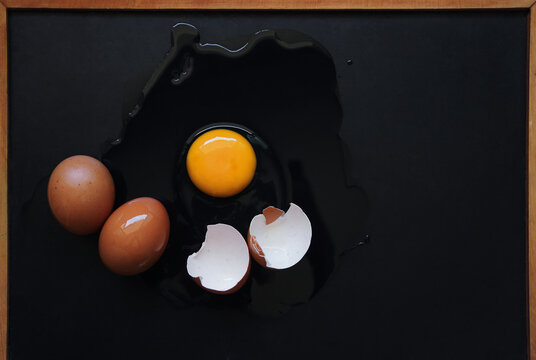 Broken egg on the black floor
