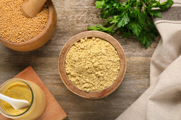 Flat lay composition with mustard powder, seeds and parsley on wooden table