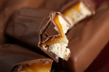 Tasty chocolate bars with caramel, closeup view
