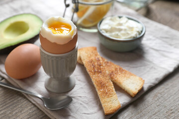 Soft boiled egg served for breakfast on wooden table