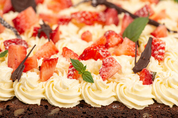 Deliciously rich cake brownie slice with Chantilly cream and fresh strawberry.